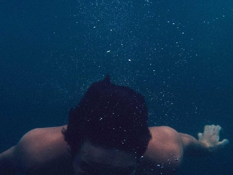 Coral-stone boutique hotel entrance with traditional carved Maldivian screens