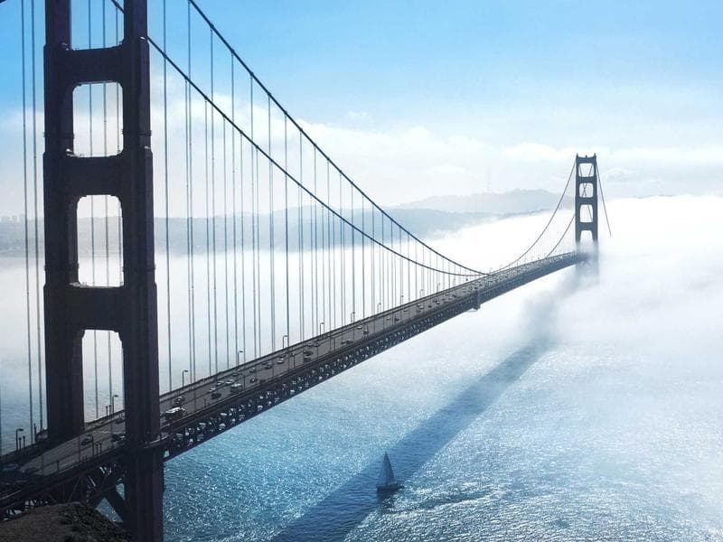 Compact harbour-view room with rattan headboard and warm linen at On Riva